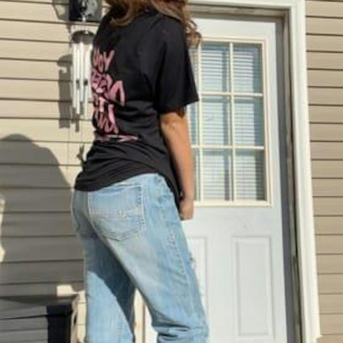 Customer in You Deserve To Be Loved black tee with oversized fit, outdoor porch
